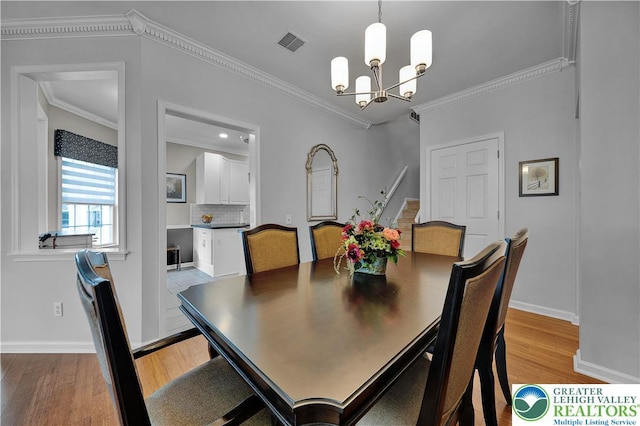 4693 Bluegrass Ln, Lower Macungie Twp, PA 18062 - dining area featuring a chandelier, light wood-style floors, and crown molding