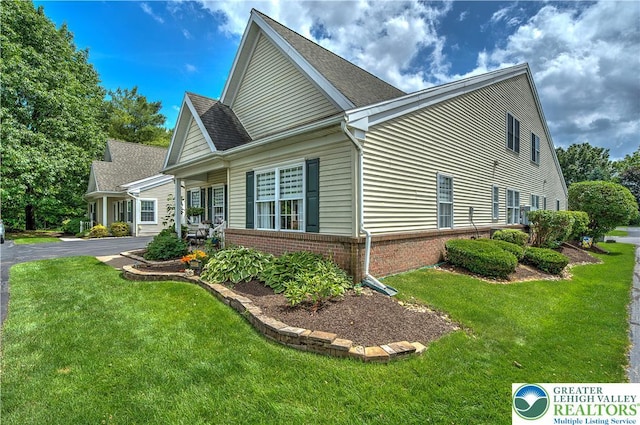 4693 Bluegrass Ln, Lower Macungie Twp, PA 18062 - view of side of home featuring brick siding and a lawn