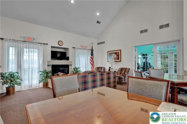 4693 Bluegrass Ln, Lower Macungie Twp, PA 18062 - dining room featuring high vaulted ceiling, a glass covered fireplace, carpet, and recessed lighting