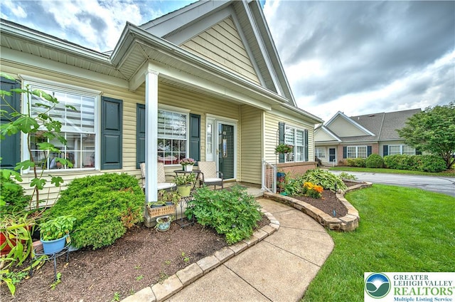 4693 Bluegrass Ln, Lower Macungie Twp, PA 18062 - property entrance featuring covered porch and a yard