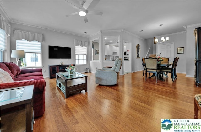4693 Bluegrass Ln, Lower Macungie Twp, PA 18062 - living area featuring light wood-type flooring, a chandelier, ceiling fan, and crown molding