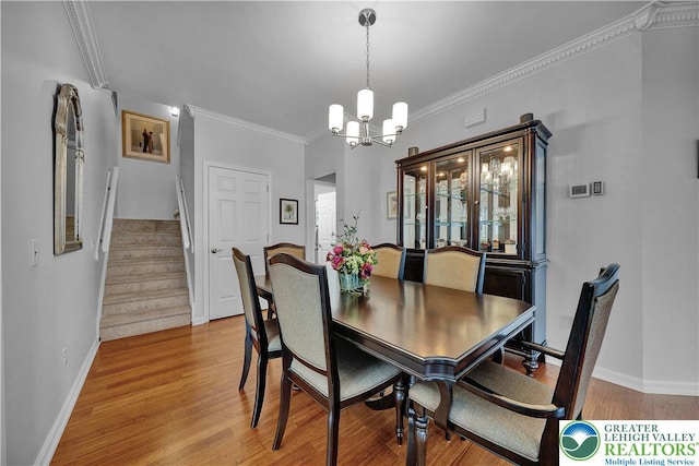 4693 Bluegrass Ln, Lower Macungie Twp, PA 18062 - dining room with a chandelier, stairs, ornamental molding, and light wood-style flooring