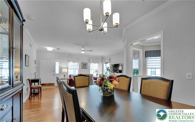 4693 Bluegrass Ln, Lower Macungie Twp, PA 18062 - dining space featuring crown molding, a chandelier, light wood-style flooring, and a ceiling fan