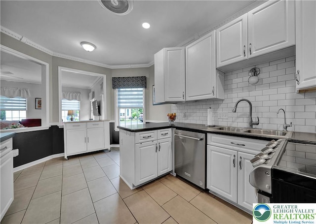 4693 Bluegrass Ln, Lower Macungie Twp, PA 18062 - kitchen featuring stainless steel appliances, white cabinets, tasteful backsplash, light tile patterned floors, and a peninsula