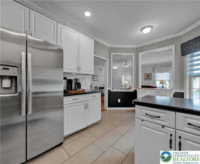 4693 Bluegrass Ln, Lower Macungie Twp, PA 18062 - kitchen featuring stainless steel fridge, dark countertops, ornamental molding, white cabinetry, and light tile patterned flooring