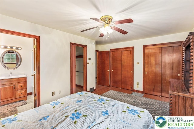 194 Gallagher Rd, Whitehall Twp, PA 18052 - bedroom featuring two closets, ensuite bath, a ceiling fan, and light wood-style floors