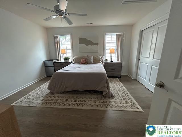1051 Resolution Dr, Hanover Twp, PA 18017 - bedroom featuring multiple windows, a ceiling fan, and wood finished floors