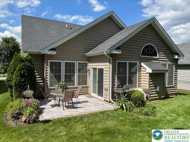 1051 Resolution Dr, Hanover Twp, PA 18017 - back of house with roof with shingles, a patio area, and a lawn