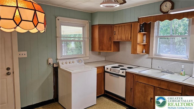 532 Oakwood St, Palmer Twp, PA 18045 - kitchen with washer / dryer, electric stove, brown cabinets, plenty of natural light, and ornamental molding