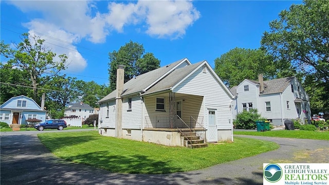 532 Oakwood St, Palmer Twp, PA 18045 - view of front of home featuring a front lawn, covered porch, and a chimney