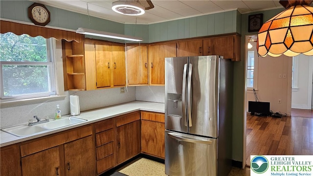 532 Oakwood St, Palmer Twp, PA 18045 - kitchen with stainless steel fridge with ice dispenser, crown molding, light countertops, brown cabinetry, and wood finished floors