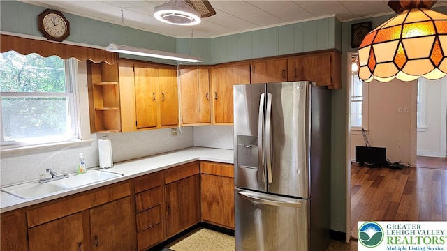 532 Oakwood St, Palmer Twp, PA 18045 - kitchen featuring stainless steel fridge, light countertops, backsplash, brown cabinetry, and ornamental molding