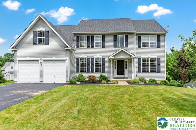 6841 Stone Croft Cir, Macungie Boro, PA 18062 - colonial-style house with driveway, a front yard, and an attached garage