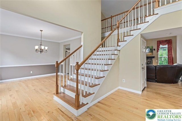 6841 Stone Croft Cir, Macungie Boro, PA 18062 - stairway featuring hardwood / wood-style flooring, ornamental molding, a chandelier, and a high ceiling