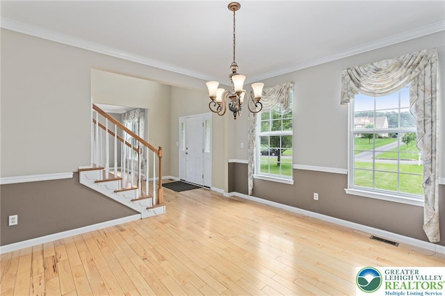 6841 Stone Croft Cir, Macungie Boro, PA 18062 - foyer entrance with a chandelier, stairway, ornamental molding, and wood-type flooring