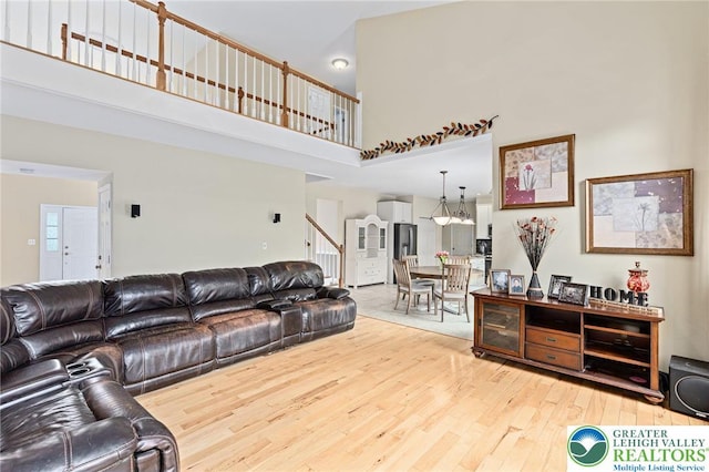 6841 Stone Croft Cir, Macungie Boro, PA 18062 - living room with a towering ceiling, wood finished floors, and stairs