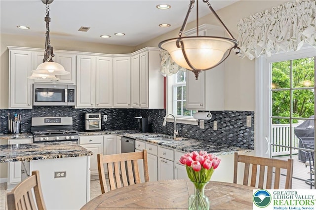 6841 Stone Croft Cir, Macungie Boro, PA 18062 - kitchen with stainless steel appliances, white cabinetry, dark stone countertops, tasteful backsplash, and recessed lighting