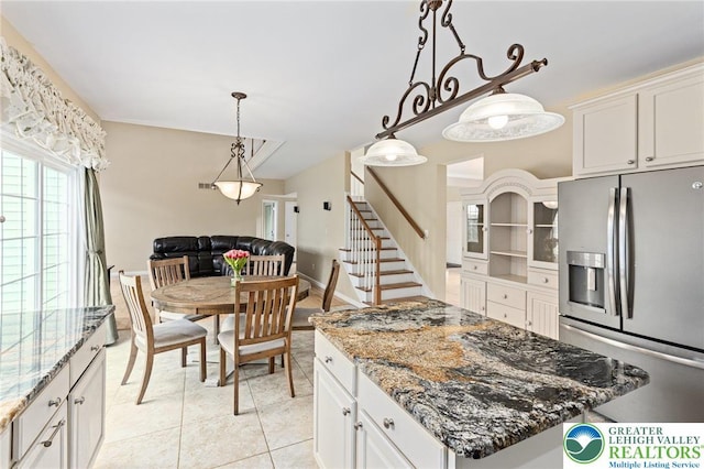 6841 Stone Croft Cir, Macungie Boro, PA 18062 - kitchen featuring stainless steel refrigerator with ice dispenser, light stone countertops, white cabinets, and decorative light fixtures
