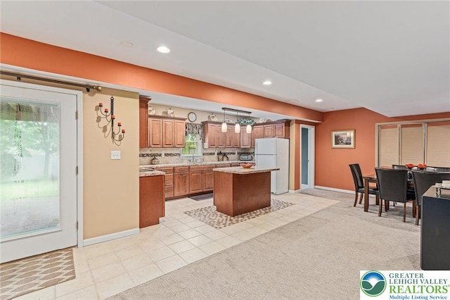 6841 Stone Croft Cir, Macungie Boro, PA 18062 - kitchen featuring freestanding refrigerator, brown cabinetry, a center island, recessed lighting, and hanging light fixtures