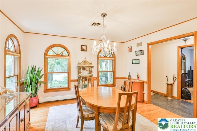 3745 Orefield Rd, South Whitehall Twp, PA 18104 - dining room with a baseboard heating unit, a chandelier, ornamental molding, and light wood finished floors