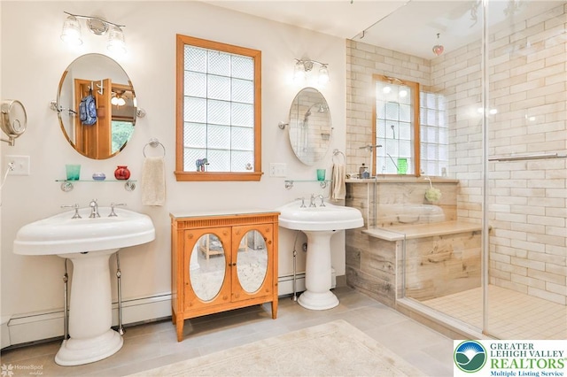 3745 Orefield Rd, South Whitehall Twp, PA 18104 - full bathroom with tile patterned floors, a baseboard radiator, a shower stall, and two sinks