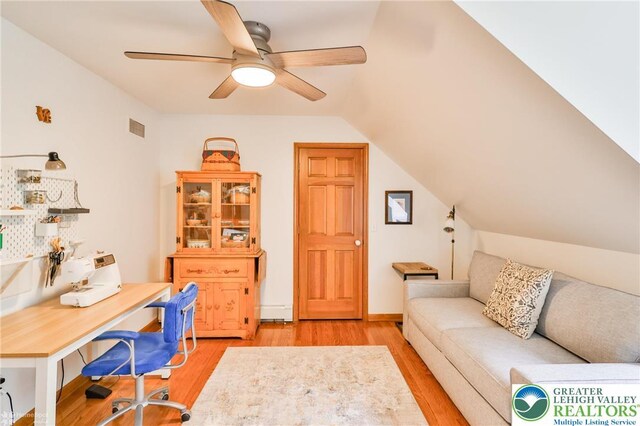 3745 Orefield Rd, South Whitehall Twp, PA 18104 - home office featuring light wood finished floors, a ceiling fan, a baseboard radiator, and lofted ceiling