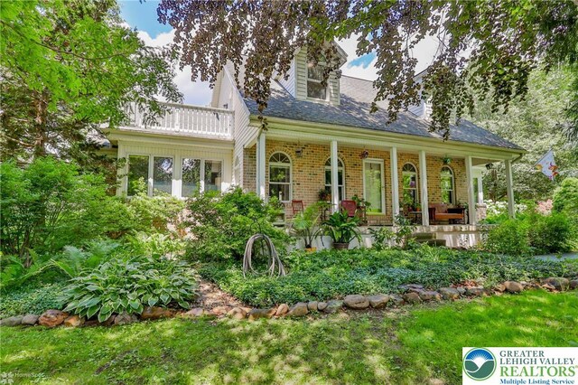 3745 Orefield Rd, South Whitehall Twp, PA 18104 - view of front of home with a balcony, a porch, brick siding, and a shingled roof