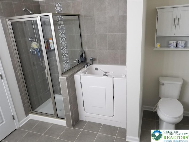 3583 Daylily Dr, Upper Milford Twp, PA 18049 - bathroom featuring tile patterned flooring, a garden tub, and a shower stall