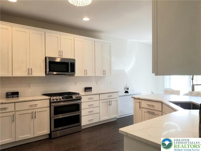 3583 Daylily Dr, Upper Milford Twp, PA 18049 - kitchen with appliances with stainless steel finishes, backsplash, recessed lighting, and white cabinets