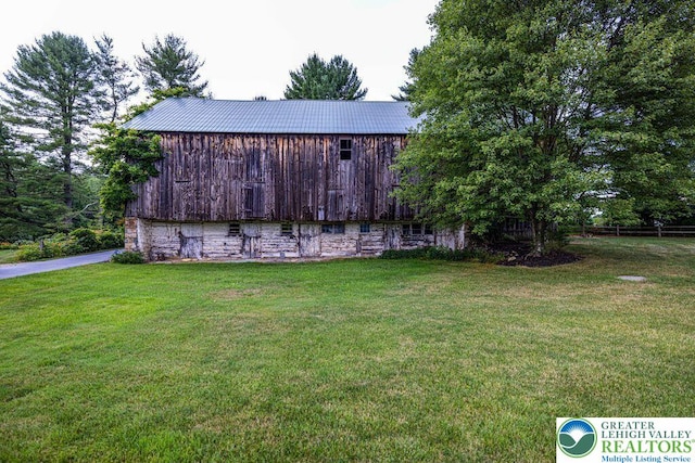 909 Interchange Rd, Polk Twp, PA 18333 - view of grassy yard featuring a barn, an outbuilding, driveway, and a garage
