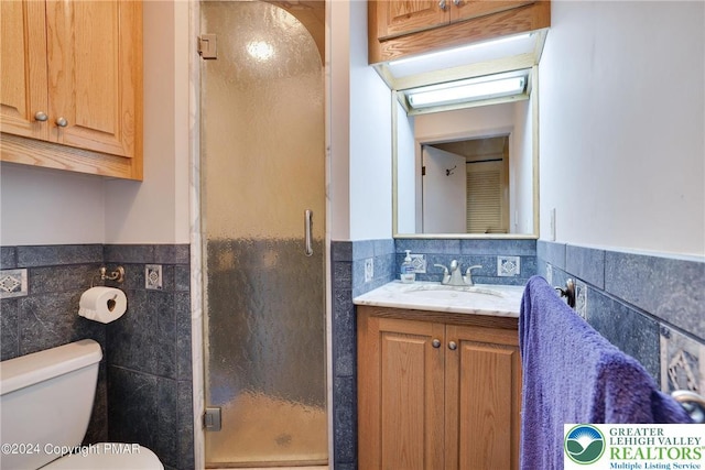 909 Interchange Rd, Polk Twp, PA 18333 - bathroom featuring tile walls, vanity, a shower stall, and wainscoting