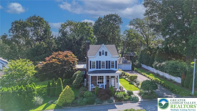 11 11 Ave, D, PA 17972 - view of front of house with a porch, a detached garage, and a chimney