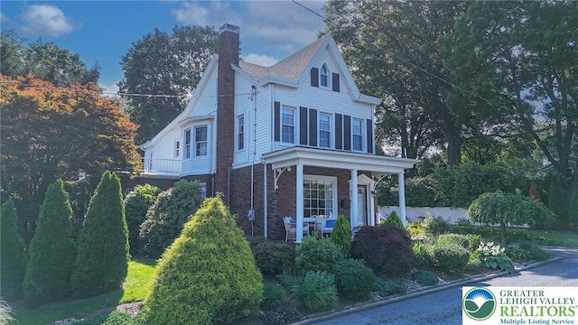 11 11 Ave, D, PA 17972 - view of home's exterior with a chimney, brick siding, and covered porch