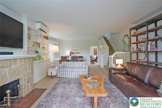 11 11 Ave, D, PA 17972 - carpeted living area with a wall mounted AC, stairs, a stone fireplace, and arched walkways