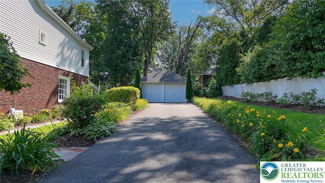 11 11 Ave, D, PA 17972 - view of side of home with a garage, brick siding, and an outdoor structure