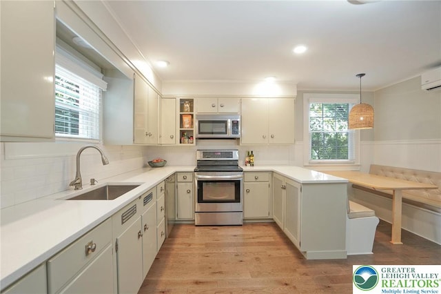 11 11 Ave, D, PA 17972 - kitchen with stainless steel appliances, decorative backsplash, light wood-style floors, light countertops, and a wainscoted wall