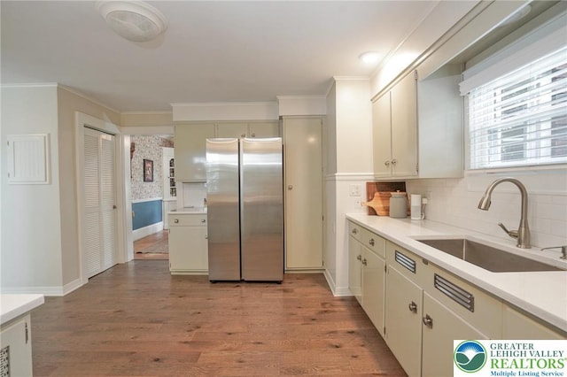 11 11 Ave, D, PA 17972 - kitchen with freestanding refrigerator, light wood-style floors, light countertops, crown molding, and decorative backsplash