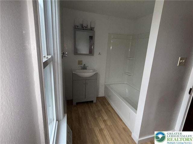 565 Moorestown Dr, Moore Twp, PA 18014 - bathroom featuring wood finished floors, vanity, and tub / shower combination