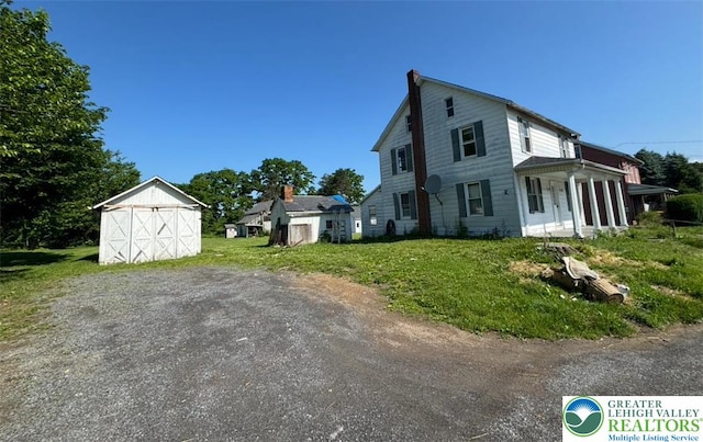 565 Moorestown Dr, Moore Twp, PA 18014 - view of home's exterior with an outdoor structure and a lawn