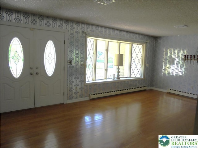2546 Wehr Mill Rd, South Whitehall Twp, PA 18069 - entryway with baseboard heating, wallpapered walls, a textured ceiling, and wood finished floors