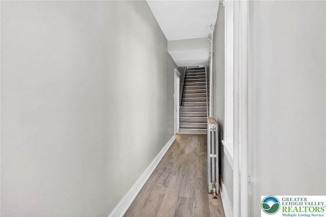 624 N Maxwell St, Allentown City, PA 18109 - corridor featuring wood finished floors, stairs, and radiator
