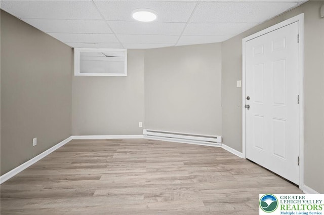 624 N Maxwell St, Allentown City, PA 18109 - finished basement with a baseboard radiator, wood finished floors, and a paneled ceiling
