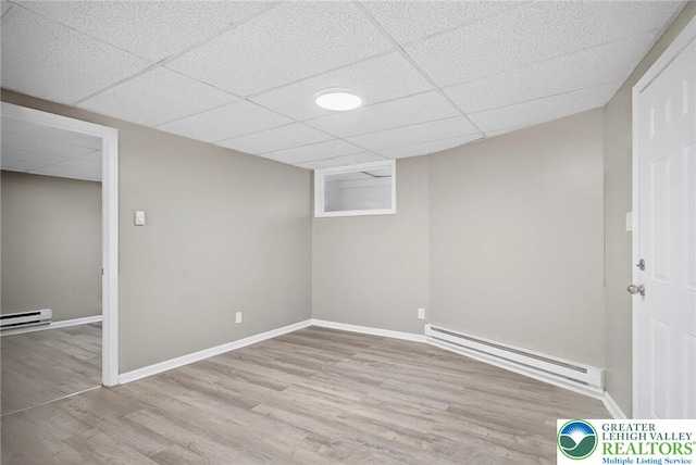 624 N Maxwell St, Allentown City, PA 18109 - finished basement with a baseboard radiator, wood finished floors, and a paneled ceiling