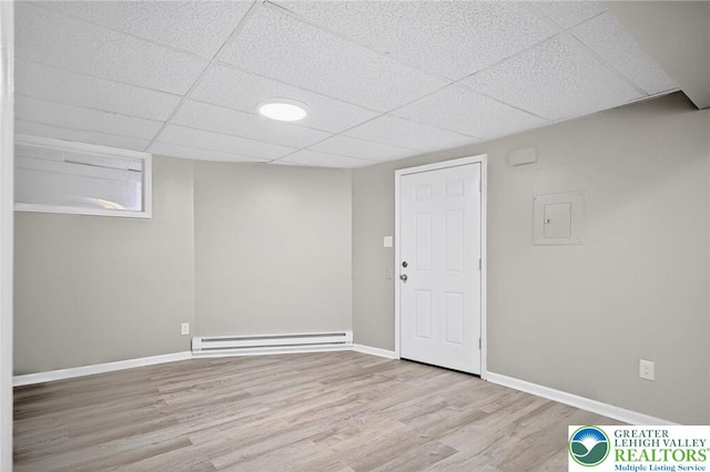 624 N Maxwell St, Allentown City, PA 18109 - finished below grade area with a baseboard heating unit, a paneled ceiling, and wood finished floors