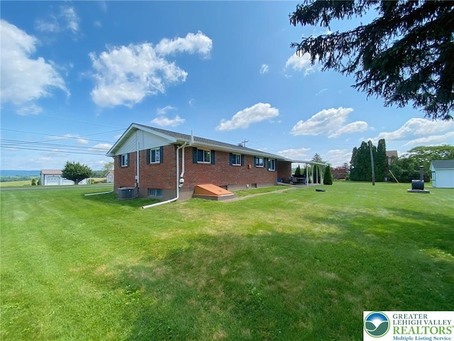3111 Pheasant Dr, Moore Twp, PA 18067 - back of house with brick siding and a lawn