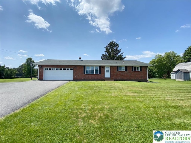 3111 Pheasant Dr, Moore Twp, PA 18067 - ranch-style home featuring a garage, driveway, a front lawn, and brick siding
