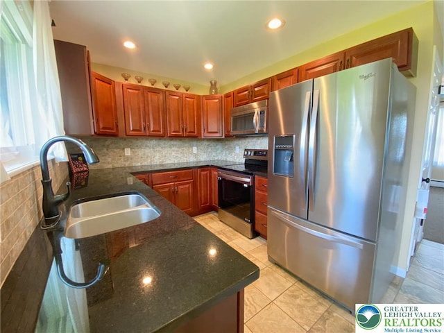 3111 Pheasant Dr, Moore Twp, PA 18067 - kitchen featuring appliances with stainless steel finishes, plenty of natural light, dark stone countertops, decorative backsplash, and recessed lighting