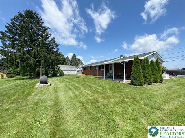 3111 Pheasant Dr, Moore Twp, PA 18067 - view of green lawn featuring a patio area