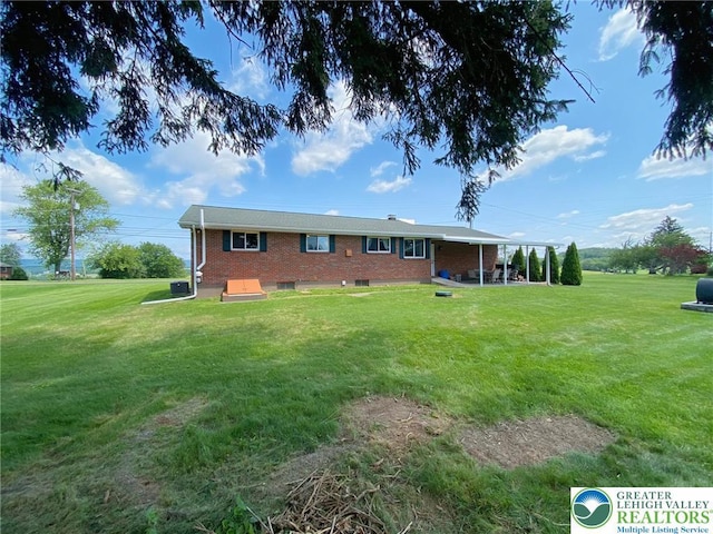 3111 Pheasant Dr, Moore Twp, PA 18067 - rear view of property featuring brick siding and a lawn
