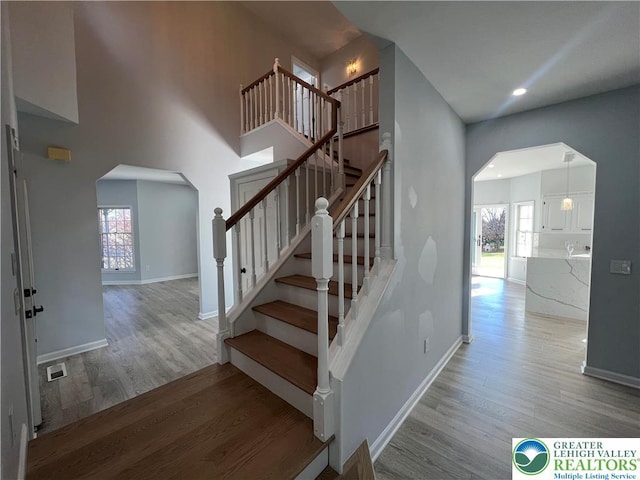 106 Lynx Ln, Chestnuthill Twp, PA 18330 - stairway featuring arched walkways, wood finished floors, plenty of natural light, recessed lighting, and a towering ceiling